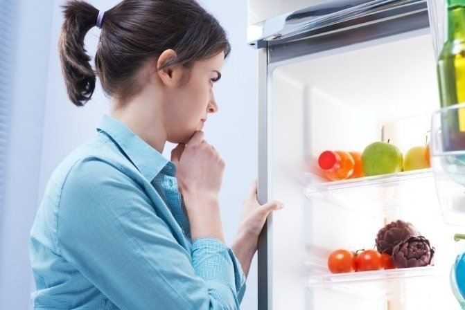 Девушка у открытого холодильника